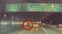 Video: Pedestrian walks across 5 Freeway during traffic