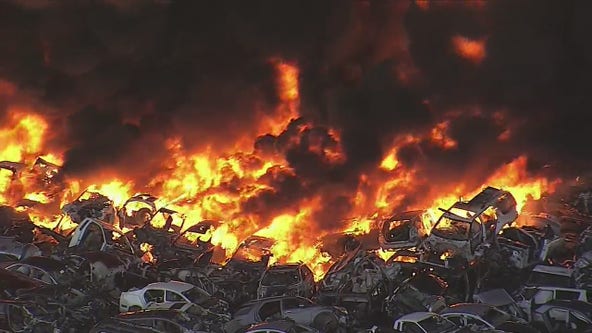 Salvage yard fire sends thick black smoke into air