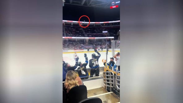 Caught on cam: Man saves boy from flying puck at minor league hockey game