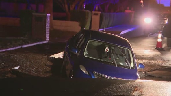 Woman rescued after driving into sinkhole in Phoenix neighborhood