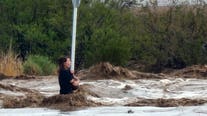 Woman holding onto stop sign rescued during flooding in Arizona