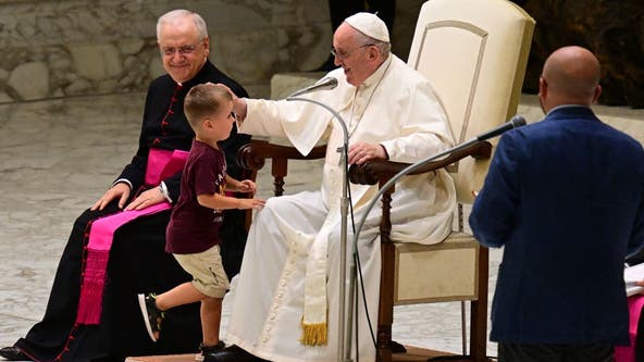 Little boy runs to Pope Francis during weekly audience