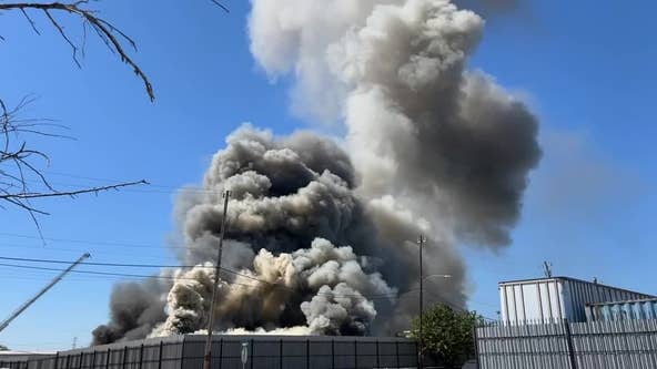 Heavy smoke rises from fire at business in southwest Houston, now 100% contained