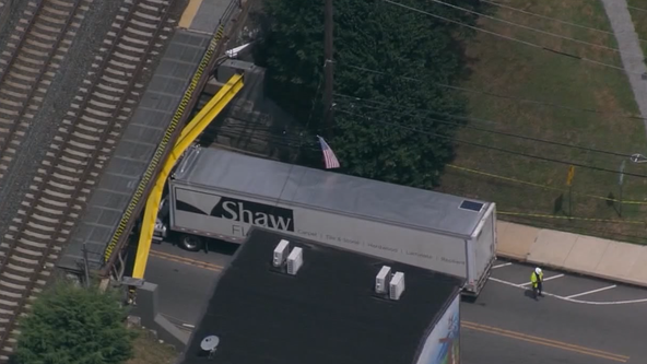 Tractor trailer strikes, gets stuck under a Delaware County Amtrak bridge