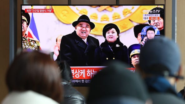 Kim Jong Un shows off daughter, missiles at North Korean parade