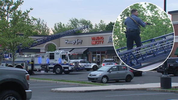 Police with guns drawn investigate shopping center in Montgomery County