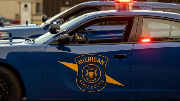 Suspect speeds away with Michigan State Police trooper hanging out of car