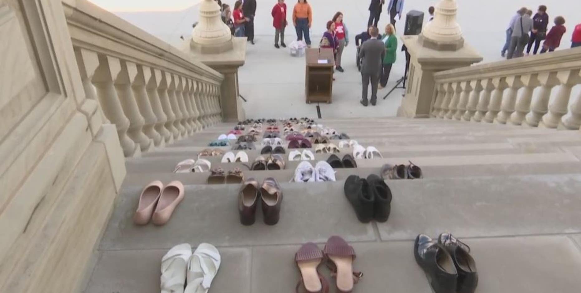 Protest with 70 pairs of shoes at State Capitol represent domestic violence victims killed by guns