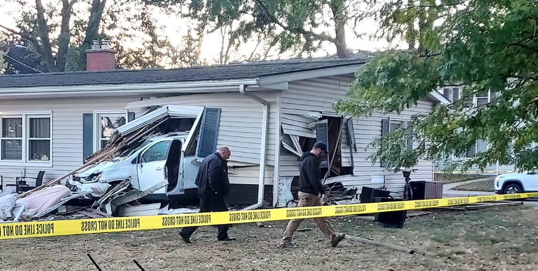 Car crashes into Center Line home, throwing sleeping child out of house