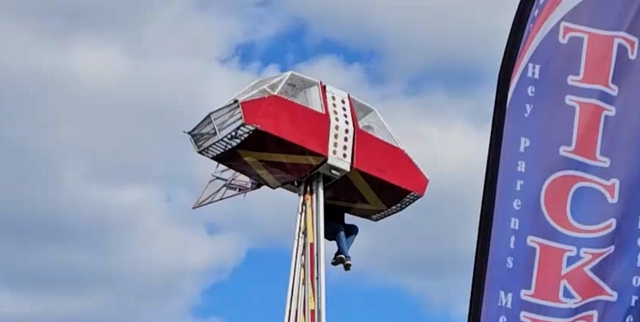 Dramatic video shows carnival worker clinging to ride to protect child after mishap