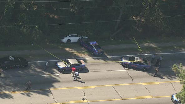 Clayton County intersection shut down while authorities attempt to arrest murder suspect, police say