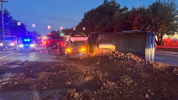 Overturned dump truck spills dirt on Buford Highway intersection, lanes shut down