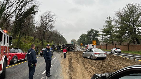 Overturned dump truck creates muddy mess on 295 in DC