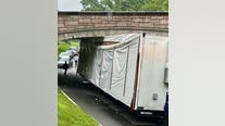 Tractor-trailer struck bridge in DC, wedged underneath: police