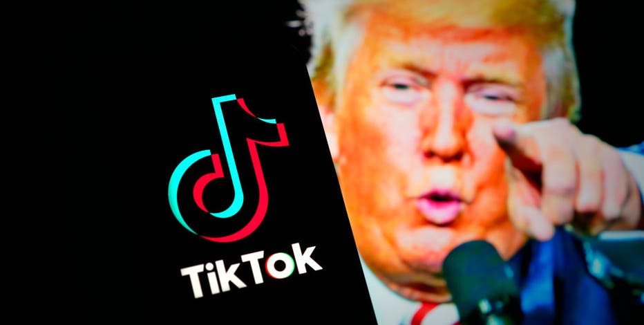 a close up of a person pointing at a tiktok sign