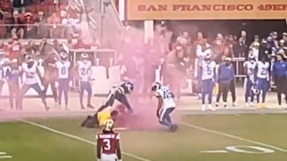 Watch: L.A. Rams player flattens protester who ran onto field