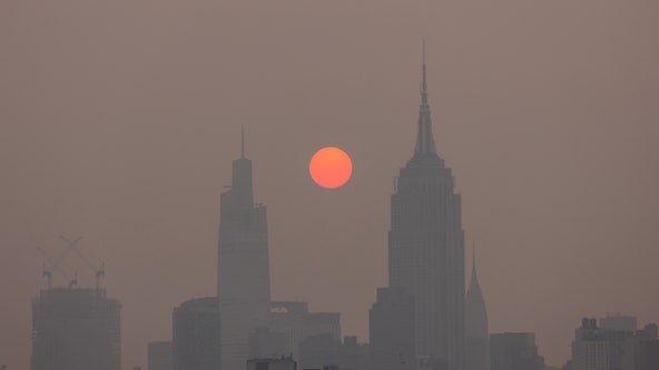 Photos: Wildfire smoke turns sun to reddish orb over Northeast