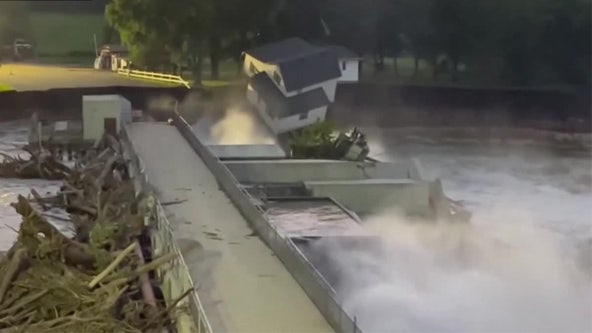 Family watches as house falls into Blue Earth River