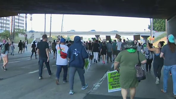 Demonstrators march on 110 Freeway by downtown LA after overturning of Roe v. Wade