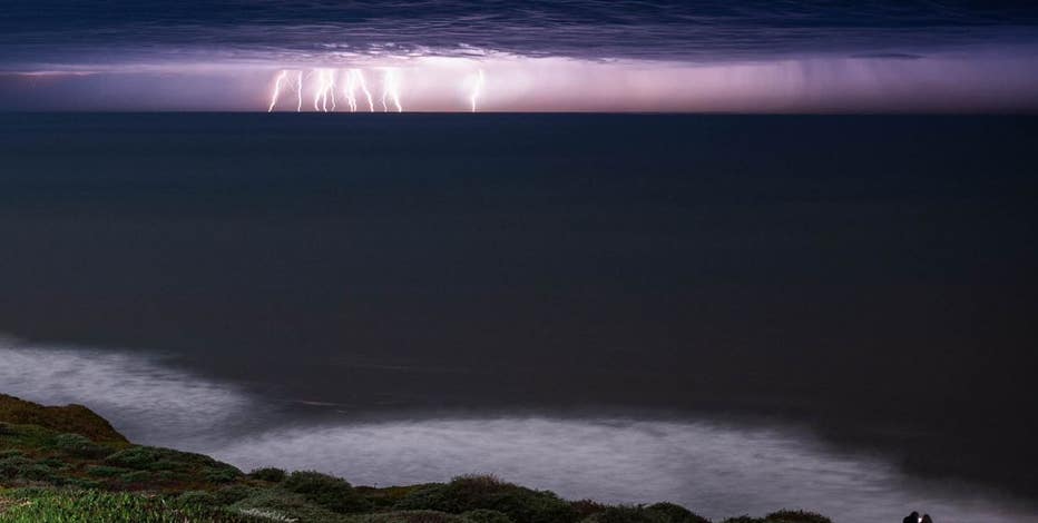 Stunning lightning flashes across purple sky in Pacifica