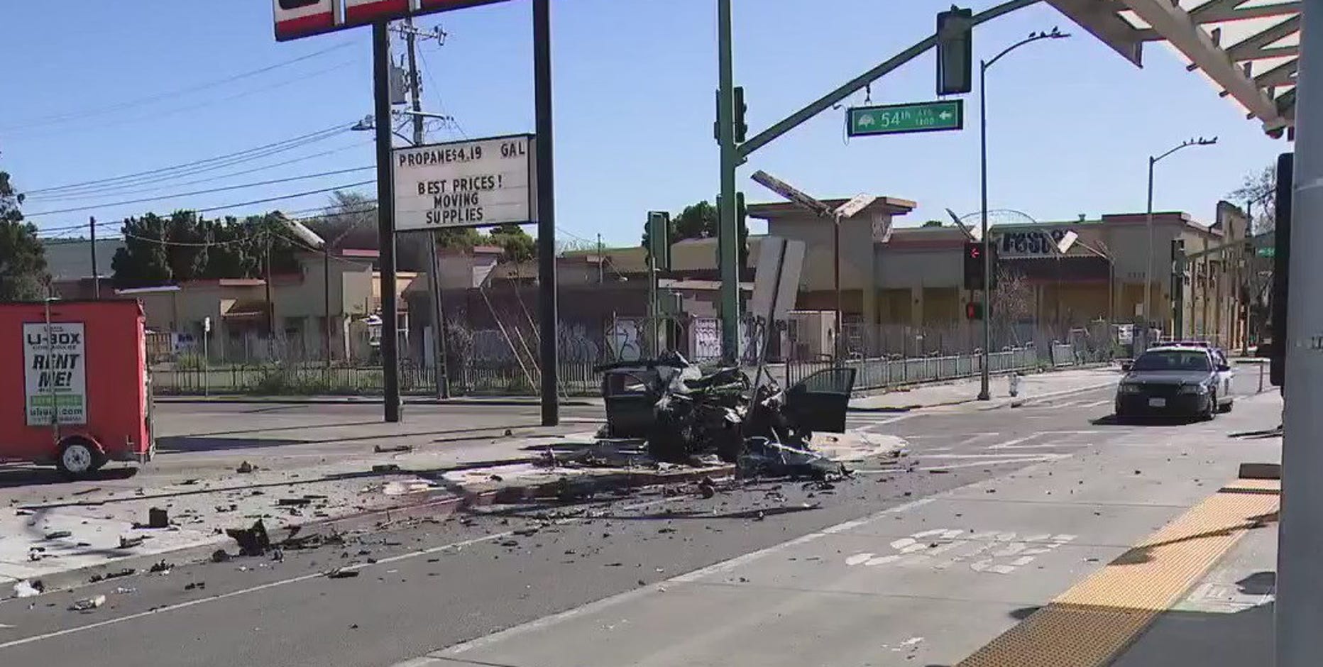 Black sedan wrapped around lamp post in Oakland; critical injury
