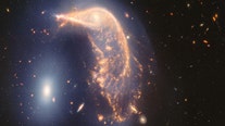 Webb Space Telescope reveals pair of glowing intertwined galaxies