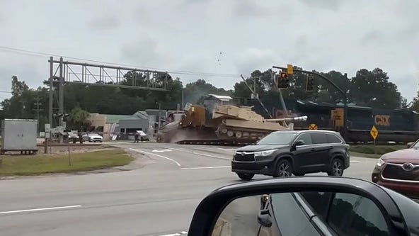 Watch: Train slams into semi carrying military tank