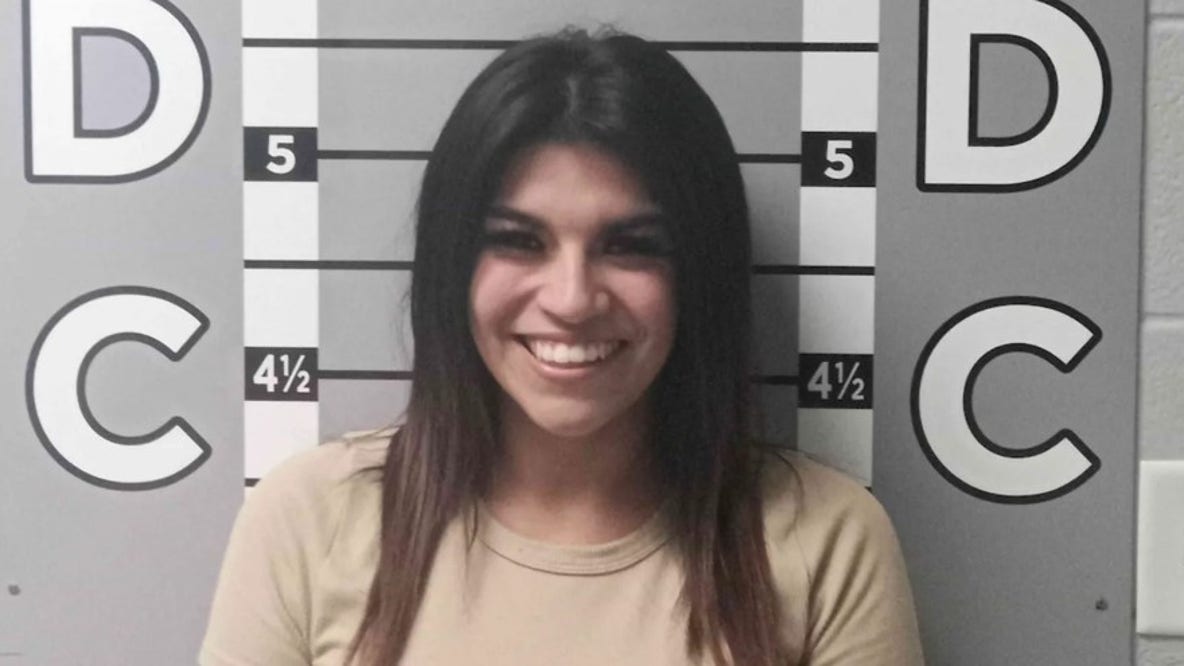 Woman's smiling mugshot goes viral after alleged $12K car vandalism spree against ex