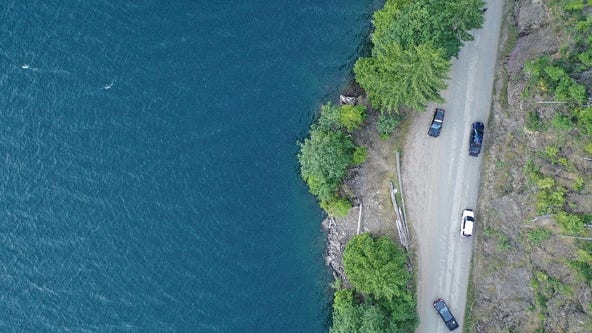 Child dies after driver goes over embankment, plunging into Lake Cushman