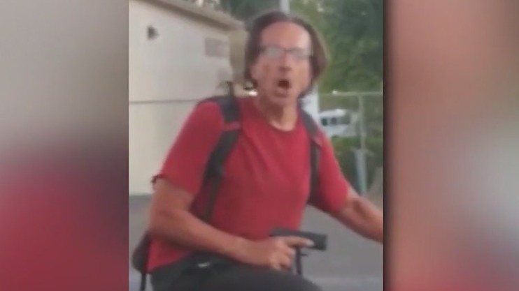 Phoenix man captured on camera aiming a gun at witnesses in a parking lot