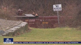 Train derailment leaves cars on riverbank and in water; no injuries, hazardous materials reported