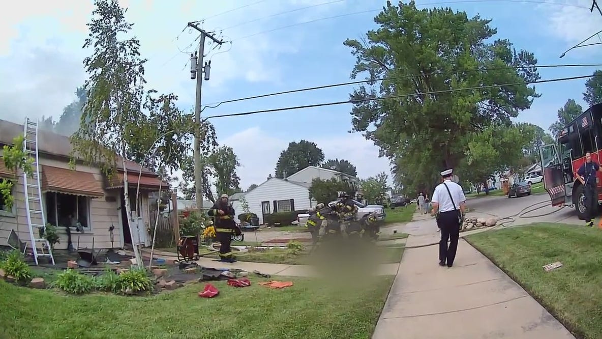 Dearborn firefighters work together to carry man from burning home