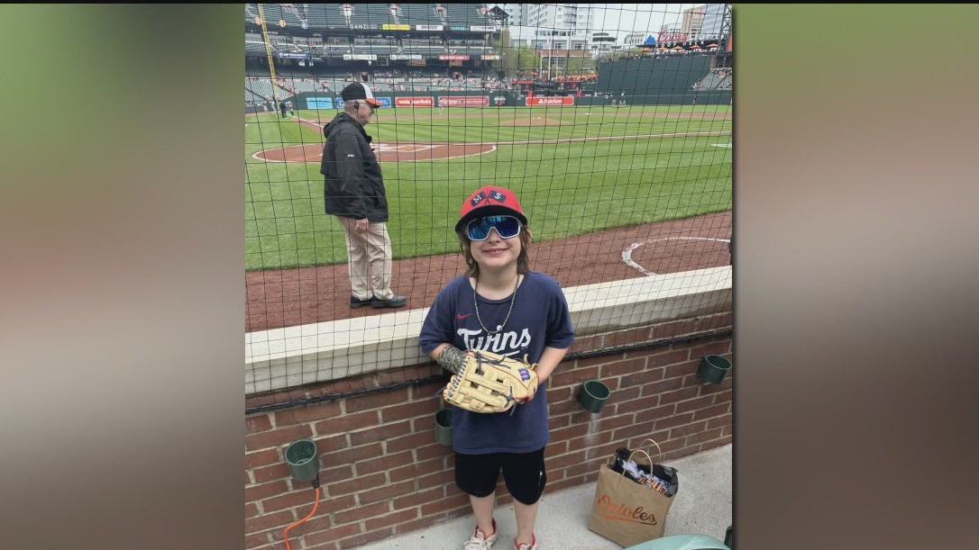 Adult fan snags signed baseball from young Twins fan