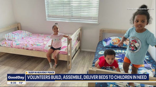 Volunteers build beds for children in need