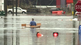 Man takes canoe for a ride through floodwater in Seattle