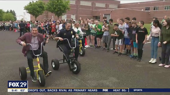 Locals teachers compete against police in tricycle relay race