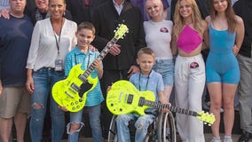 Cooper Roberts meets band 'Chicago' at Ravinia, receives signed guitars