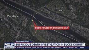 Officials say body found in burning car appears suspicious