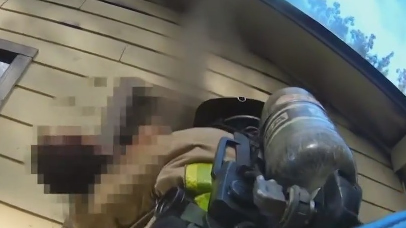 Crew rescues unconscious man from burning home
