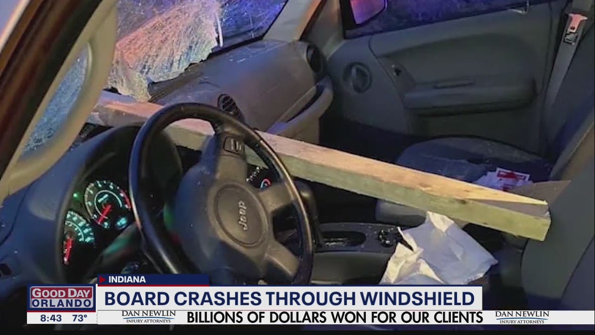 Board crashes through drivers windshield missing her by inches