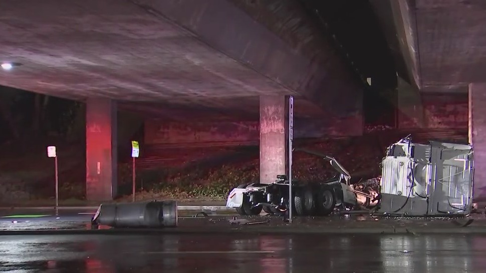 Big rig plunges off overpass, driver OK