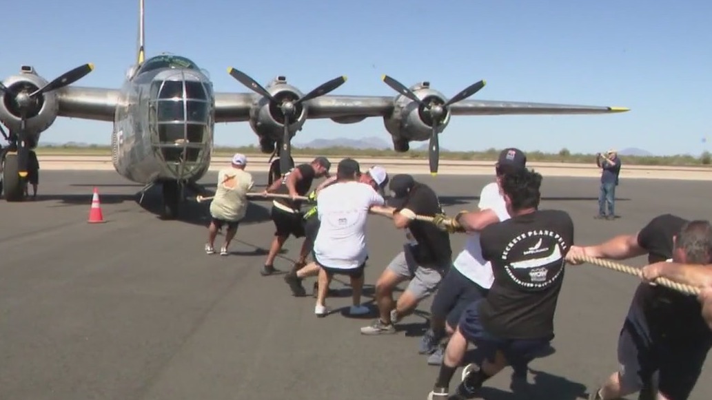 Teams compete to pull Navy plane for a good cause