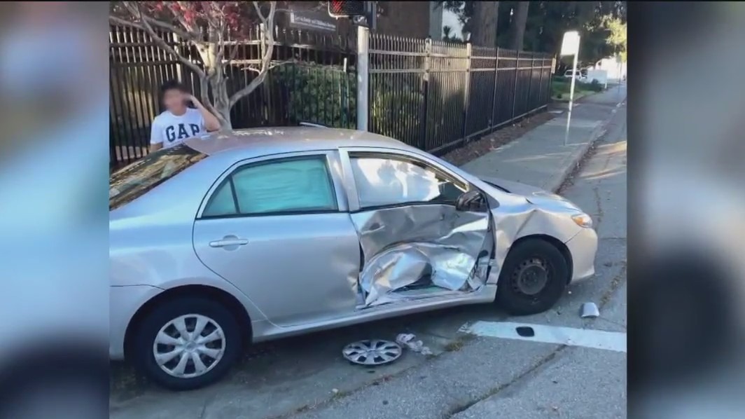 Driver allegedly ignoring emergency sirens, red light and collides with police car