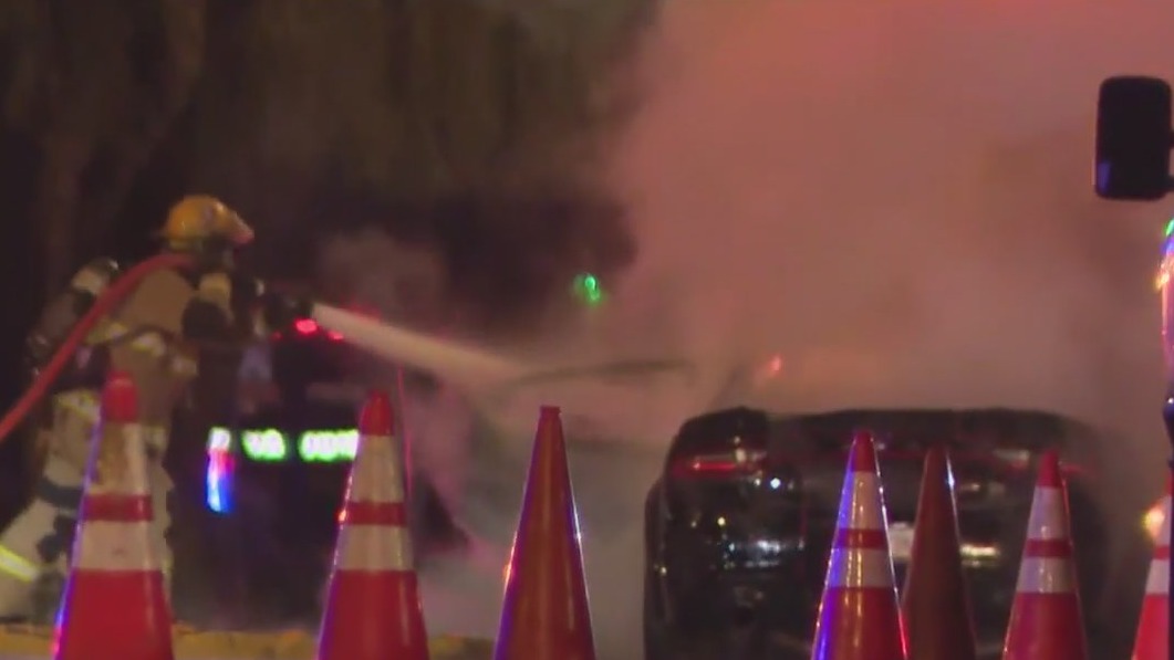 Car catches fire after crashing into tanker truck