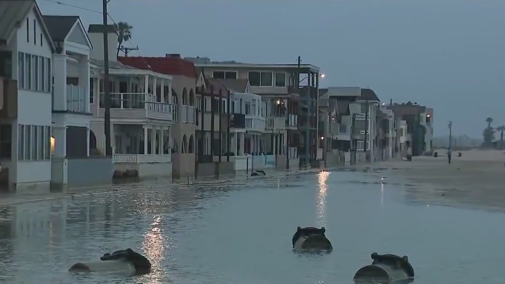 High tides flood streets, parking lots