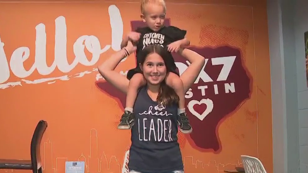 Toddler learning new cheerleading moves