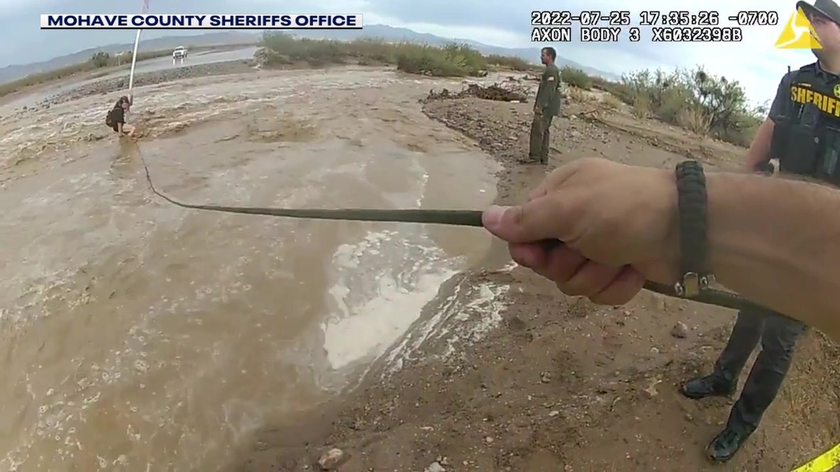 Body camera video shows swiftwater rescue of woman holding onto stop sign