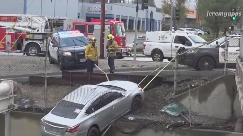 Car nearly falls off edge, hangs over wash in City of Industry