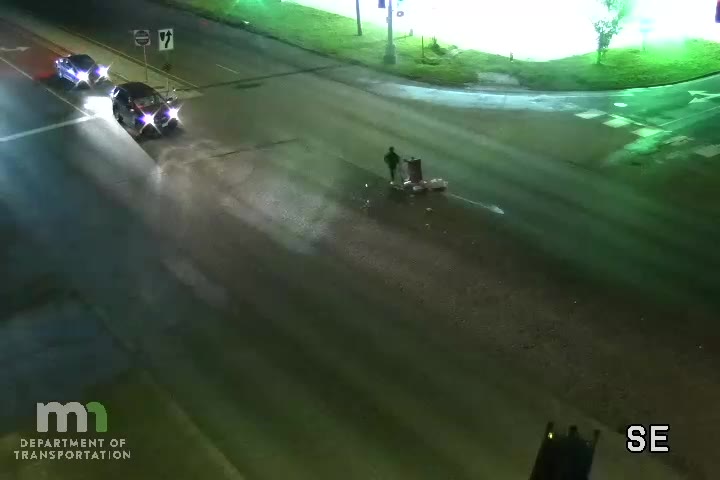 Truck drops beer on roadway, drivers stop to retrieve it in the street
