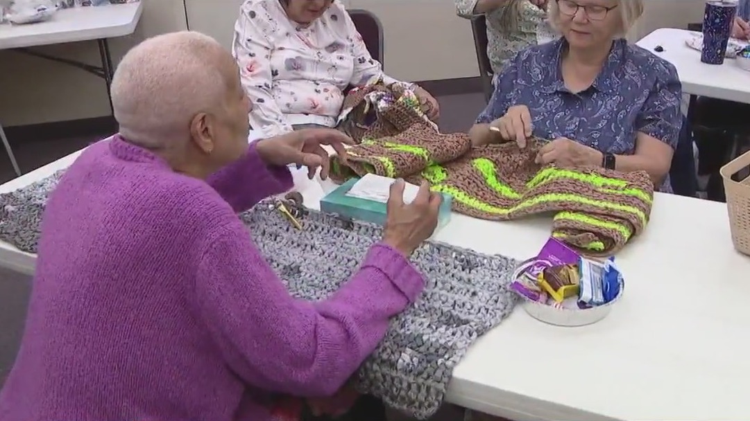 Volunteers making sleeping mats for the homeless